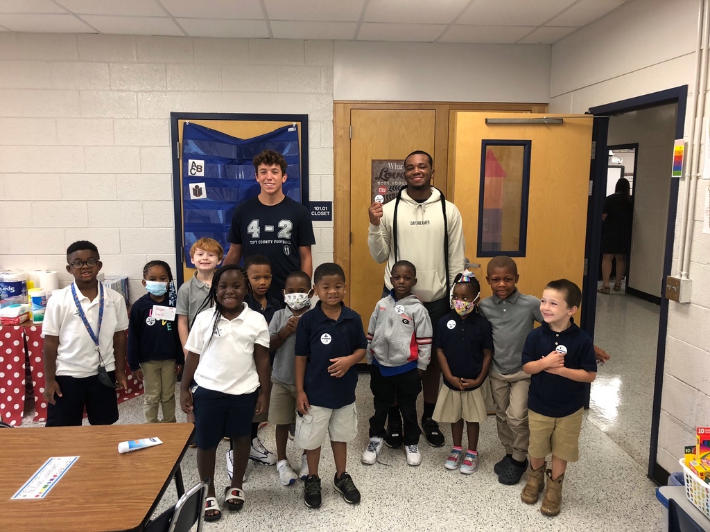 TCHS football players visit K-5 students.