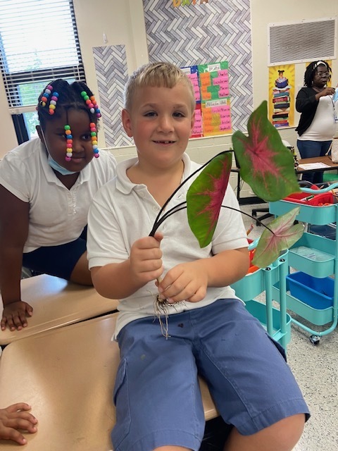student holding plant